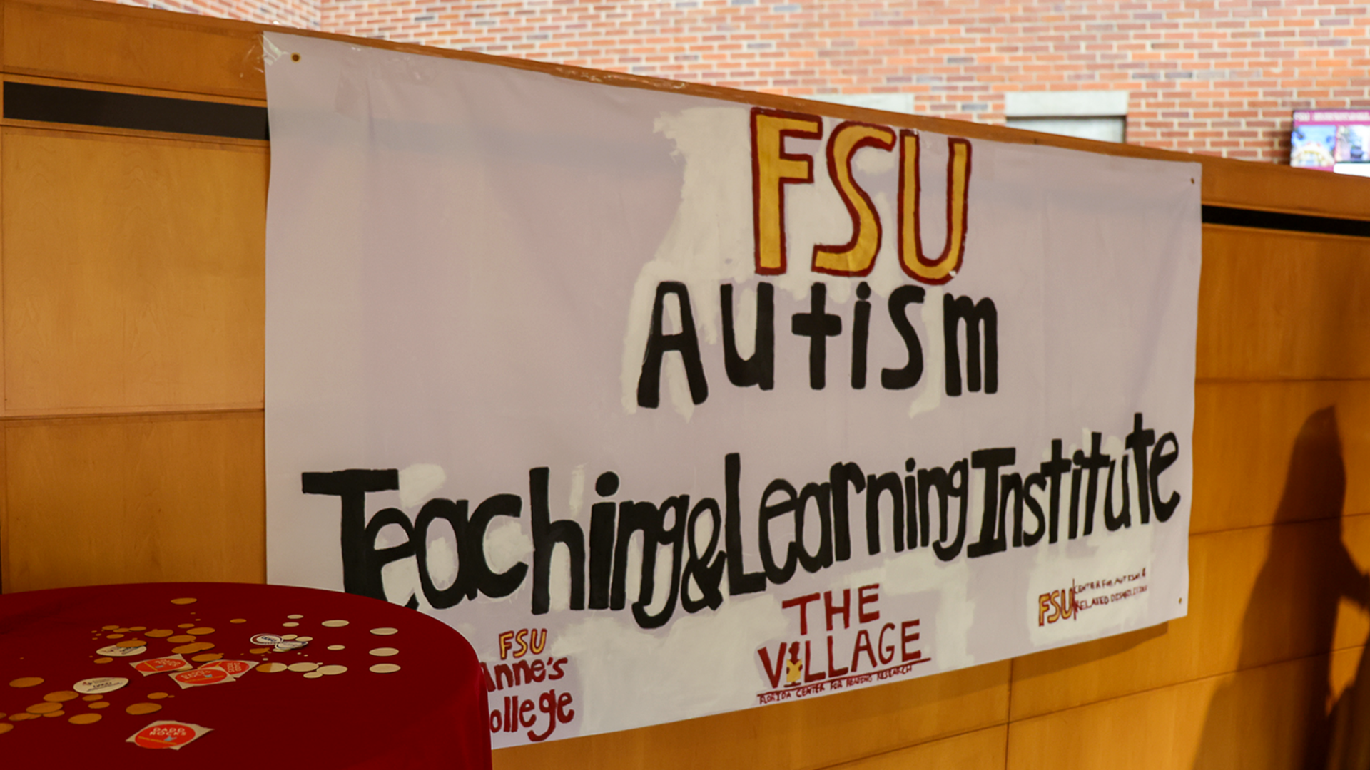 A hand-painted sign reads: FSU Autism Teaching & Learning Institute