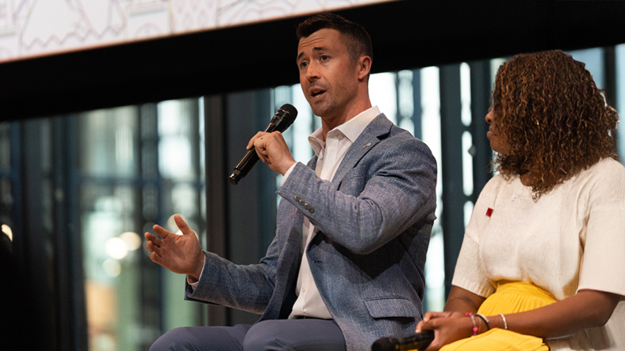 James Eggers speaking at an event, seated