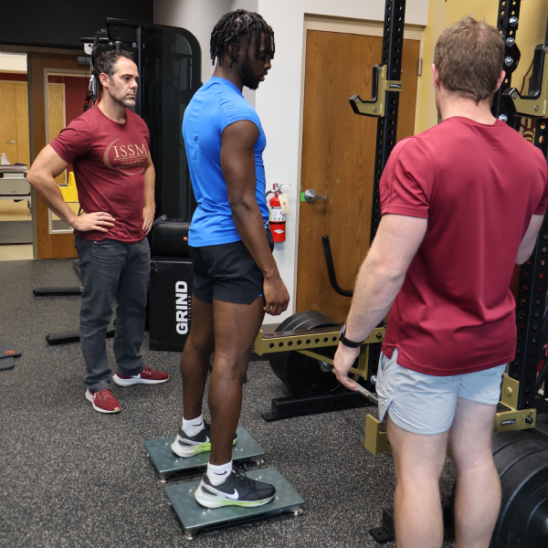 Man standing on force plates in sports science lab
