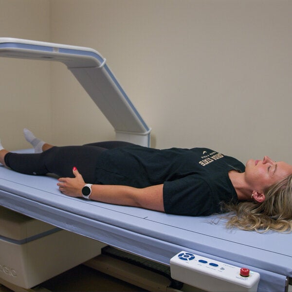 woman laying on DEXA scanner