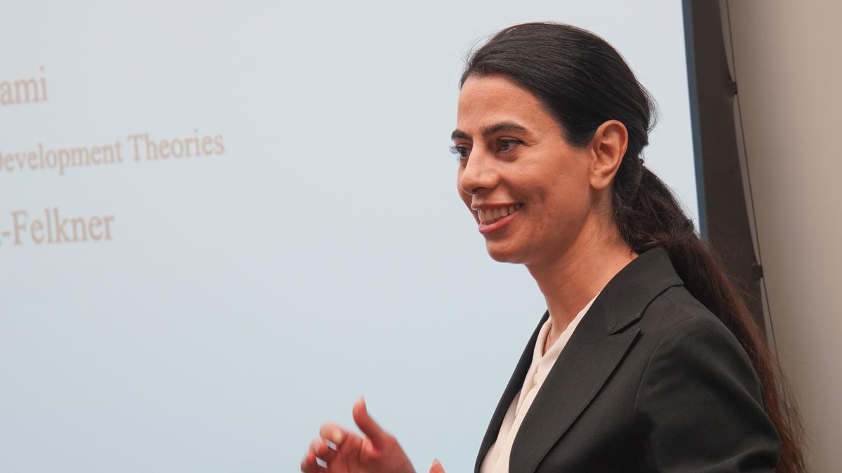 female student presenting in front of classroom