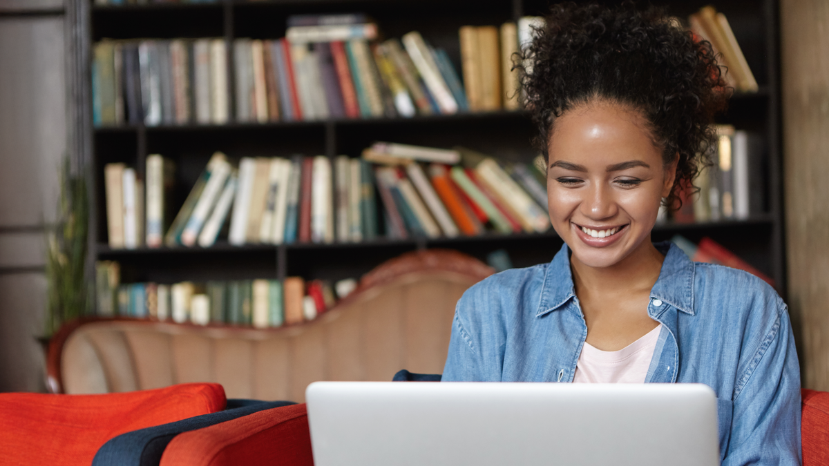 Student working on a laptop in a library