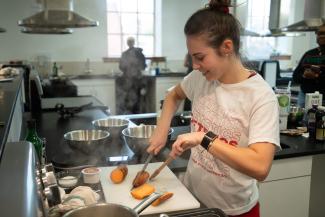 a woman slicing sweet potatoes