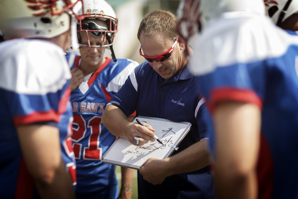 Coach giving team a pep talk