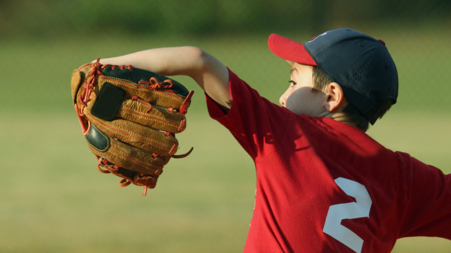 Child pitching for a baseball game