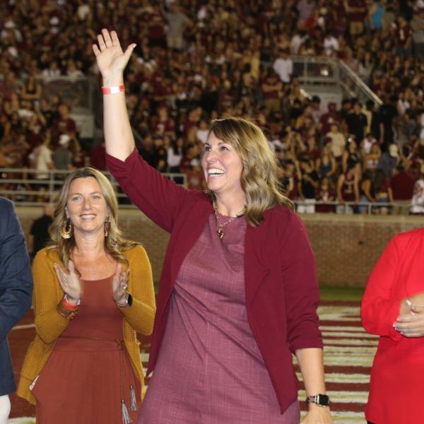 People on football field cheering