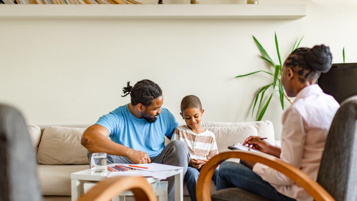 family sitting with a human development scientist