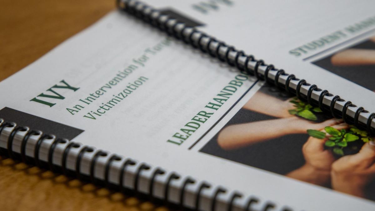 two spiral-bound booklets spread apart on a table
