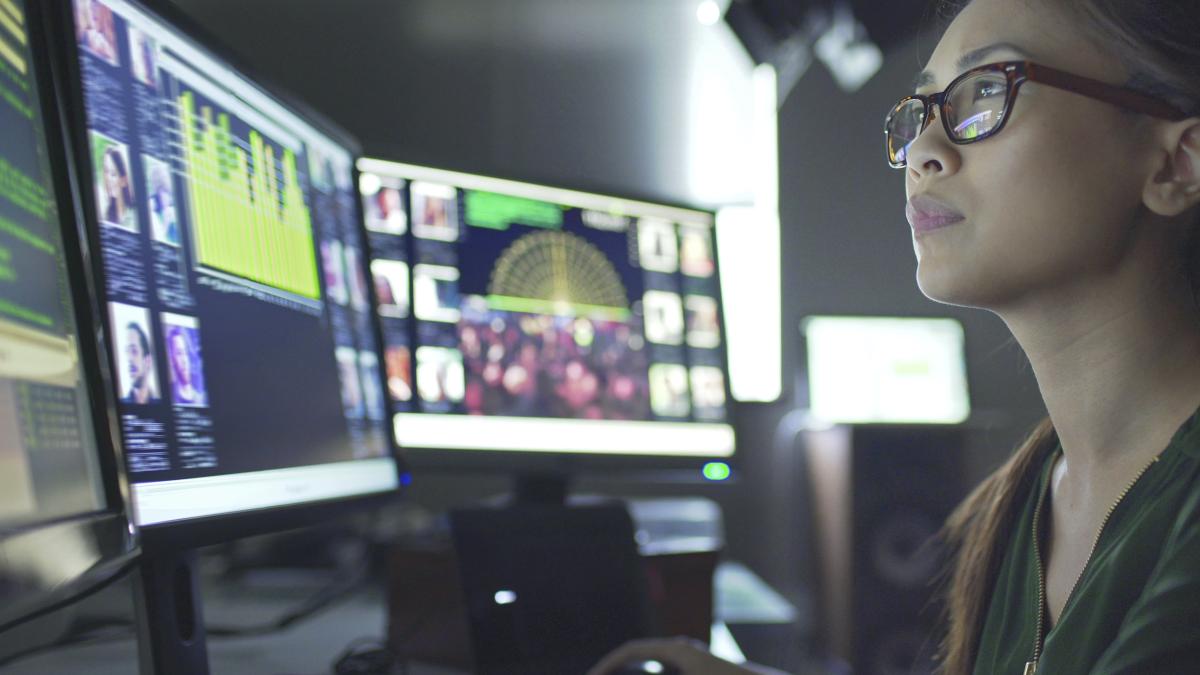 Person in front of computer screens