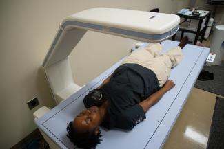 A student in a DEXA scanner