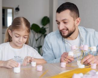 father and daughter doing a craft