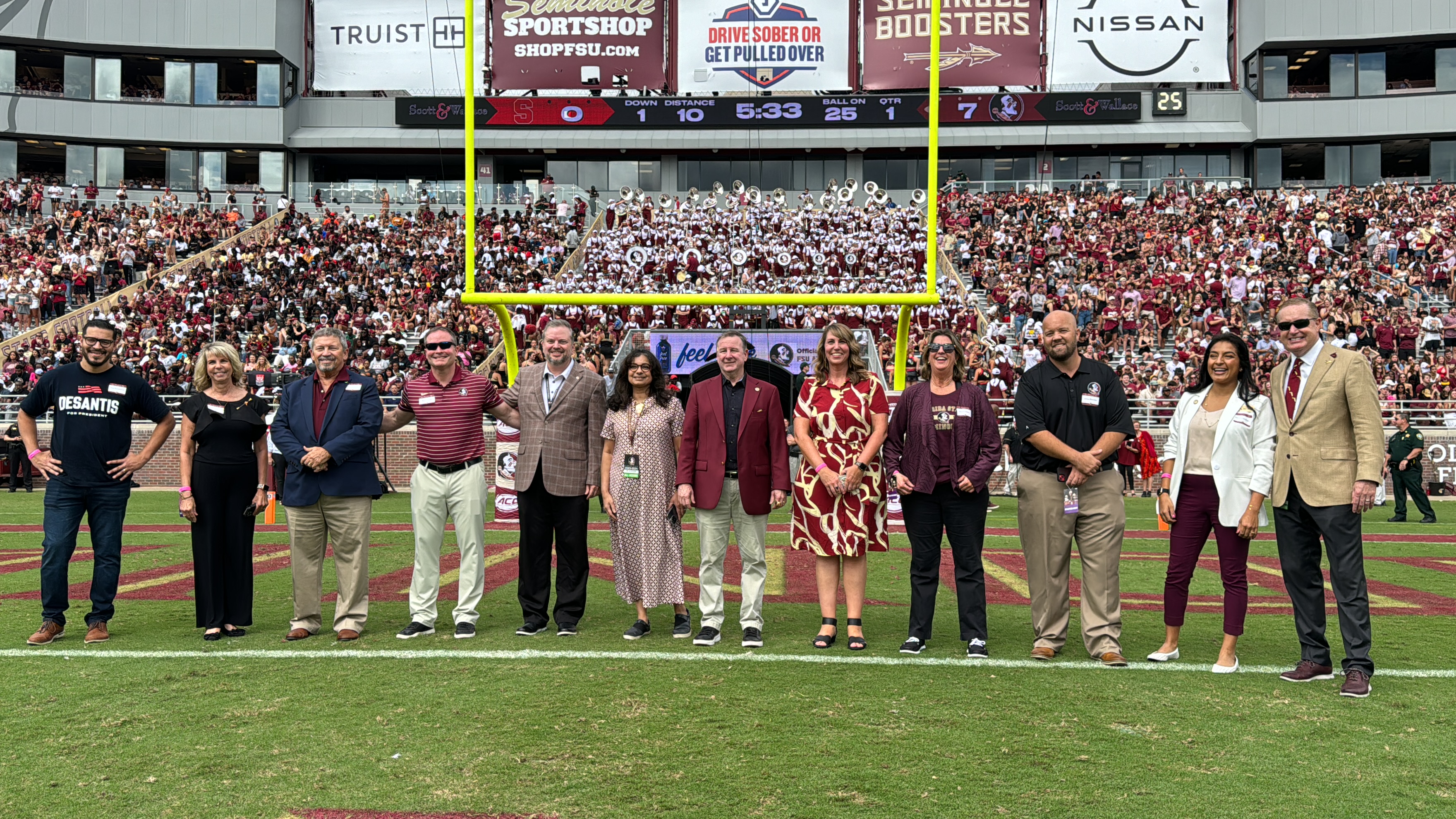 A group of individuals on-field at a football game