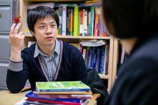 student talking to a professor in an office